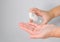 A woman`s hand is pressing an alcohol gel to wash her hands to kill bacteria and coronavirus or covid-19