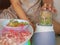 Woman`s hand pressing / securing a blender while it is blending food ingredients at home