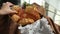 Woman`s hand puts down a cake. Fresh bread, buns and cookies. Assortment