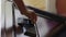 Woman's hand puts tablet for washing dishes in dishwasher. Close-up. Automatic dishwashing machine at home