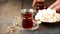 Woman`s hand puts turkish tea in traditional glass cup on the wooden table. Oriental.