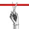 Woman`s hand with scissors cutting red ribbon
