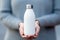 Woman\\\'s hand showcases white reusable stainless steel eco thermo water bottle