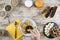 A woman`s hand soaking the biscuit in tea at a wooden table set for a sweet vegan breakfast shot from above with sliced banana,