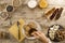 A woman`s hand soaking the biscuit in tea at a wooden table set for a sweet vegan breakfast shot from above with sliced banana,