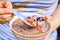 Woman`s Hand Spoons Chinese Grain Porridge with Jujube & Goji Berry on Top