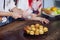 Woman& x27;s hand sprinkling icing sugar over fresh muffins. close up