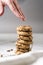 Woman`s hand steals chocolate chips cookies.