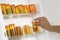 Woman\'s Hand Taking Pill Bottle From Shelf