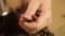 Woman\'s hand touching roasted coffee beans, preparing to enjoy strong taste