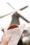 Woman`s hand with traditional dutch food - waffles with caramel on background of dutch windmill