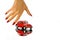 woman\'s hand trying to catch a toy red car