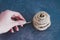 Woman`s hand untangling ball of thread by pulling string