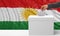 Woman`s hand is voting with a waving Kurdistan flag background, 3d illustration