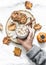 Woman`s hand in a warm sweater holds cup of hot chocolate. Cookies with chocolate chips and mug of hot chocolate on a light