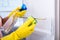 Woman`s Hand Wearing Yellow Gloves Cleaning Open Refrigerator