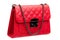 Woman`s handbag with red leather square pattern and metal strap.