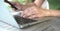 Woman`s hands busy typing on keyboard and cell phone