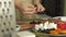 Woman`s hands closeup preparing products for pizza and preparing it for baking