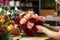 Woman\\\'s hands crafting a floral composition in a small business shop