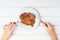 Woman`s hands cuts beef steak on white background