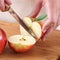 Woman\'s hands cutting apple