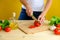 Woman\'s hands cutting fresh tomatos