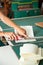 Woman\'s Hands Cutting Paper Using Blade On Table