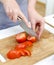 Woman\'s hands cutting tomatoes