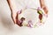 Woman`s hands hold foam wreath with sprint flowers