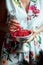Woman`s hands holding bowl of currants, close up