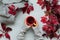 Woman`s hands holding cup of tea with red leaves of girlish wild grape or parthenocissus on gray wooden background. Top view