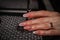 Woman`s hands holding glass of wine