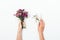 Woman`s hands holding small bouquet and tiny gift box