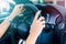 Woman`s hands holding a steering wheel of a luxury car