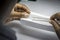 Woman`s hands inspecting rough diamonds with forceps.