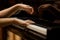 Woman\'s hands on the keyboard of the piano closeup