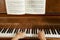 Woman\'s hands on the keyboard of the piano closeup