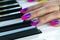 Woman`s hands on the keyboard of the piano closeup. Hands musician playing the piano. Top view. Hands pianist playing music on th