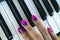 Woman`s hands on the keyboard of the piano closeup. Hands musician playing the piano. Top view. Hands pianist playing music on th