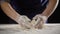 Woman`s hands kneading the dough on the table