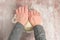 Woman’s hands kneading raw bread dough on a clear plastic mat, preparation for baking fresh bread