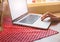 Woman`s hands on the laptop. Beautiful flowers and linen tablecloth. Perfect working place at home. Freelance concept. Searching