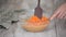 Woman's hands mixing batter for carrot cake.