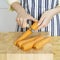 Woman& x27;s hands peeling carrot with a peeler. Conceptual image