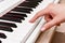 Woman`s hands playing electronic digital piano at home. The woman is professional pianist arranging music using piano electronic