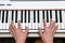 Woman`s hands playing electronic digital piano at home. The woman is professional pianist arranging music using piano electronic