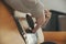 A woman`s hands playing guitar in a cozy bedroom.