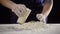 Woman`s hands pour the milk to dough for kneading