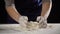 Woman`s hands pour the milk to dough for kneading